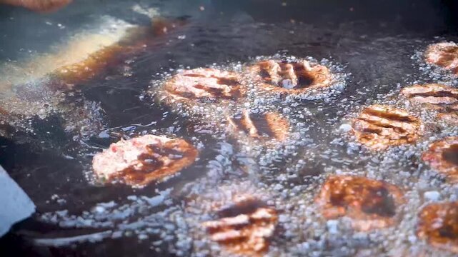 Slow motion shot of cooking of traditional Pakistani street food chappal kabab