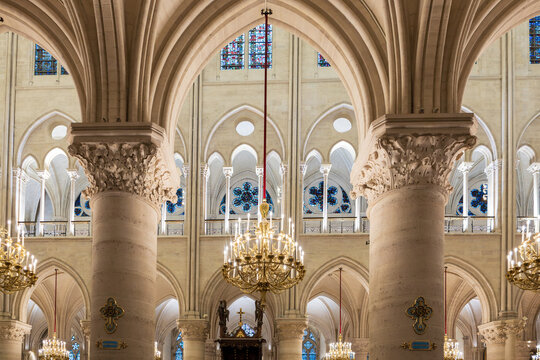 Gilded chandeliers, columns and architectural details of the 1345 Gothic style Notre-Dame Cathedral