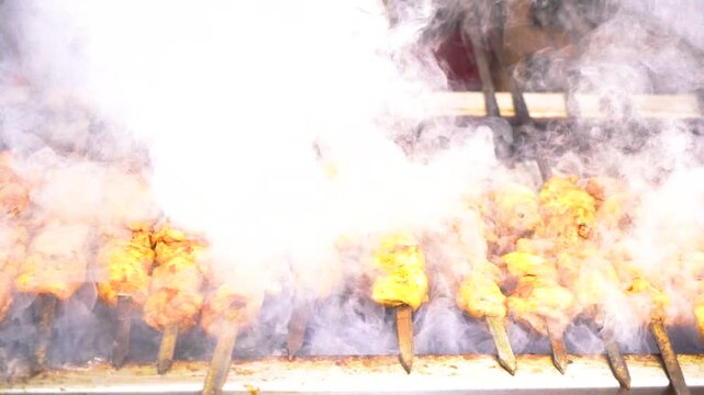 slow motion shot of Traditional bar b q of mutton at charsi tikka shop, Peshawar, Pakistan