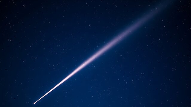 A brilliant meteor streak with a glowing tail in a star-filled night sky.