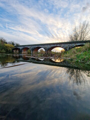 Sunset Reflections on River Trent: Swan Sanctuary, Historic Bridges, and Cloudscape, Burton, UK