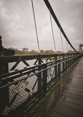 Moody Symmetry: Wet Wooden Deck of Ferry Bridge Under a Heavy Overcast Sky, Burton upon Trent, UK