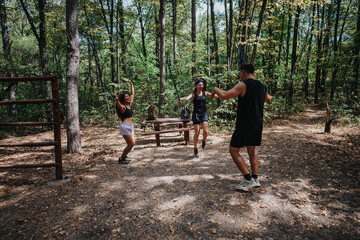 A group of friends exercises outdoors in a wooded park, jumping rope together. The forest setting, sunlight through trees, and casual athletic wear convey health, energy, teamwork, and outdoor fitness