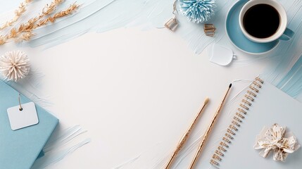 A top-down view of a desk with various items arranged, including a coffee cup, notebook, brushes, and decorative elements, set against a textured background.