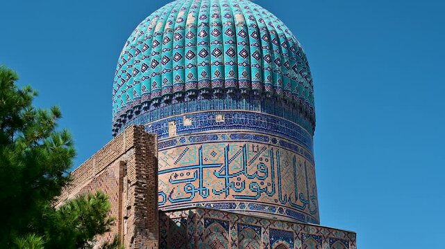 Wide shot of the blue dome of Bibi Khanym Mosque in Samarkand, Uzbekistan, showing intricate Islamic tilework and historic architecture.