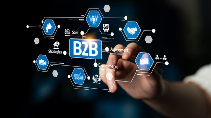 A hand engages with a digital screen emphasizing B2B themes such as e-commerce, agreements, and strategies, highlighting modern business interactions and innovation. Tessel