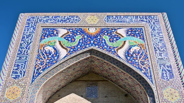 A close view of the Nodir Devonbegi Madrasah facade in Bukhara, Uzbekistan, highlighting ornate tilework and Islamic geometric decoration.