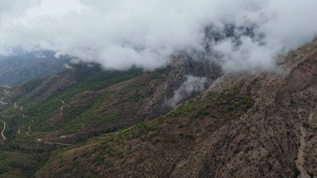 Aerial Drone POV around Cruz del Cielo mountain in the Nerja, which is a municipality on the Costa del Sol in the province of Malaga in the autonomous community of Andalusia in southern Spain.