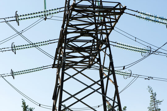 High voltage power line on blue sky background in Sunny day. wires, problems with electricity, power transmission. power line construction of cable supports and insulators. blackout, crisis