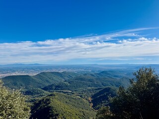 Panoramic view from Rocacorba mountain of valley, mountains, and sea