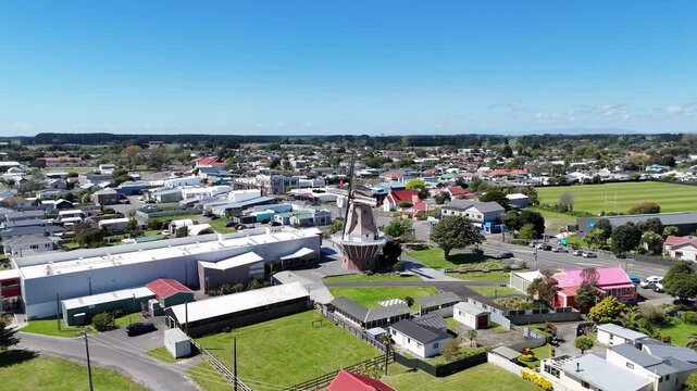 Aerial view of the iconic windmill standing tall amidst the town's buildings and green spaces, capturing the essence of the area, Foxton, Manawatu-Whanganui Region, New Zealand.