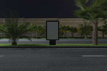 Eye-catching digital billboard stands tall along a tropical roadside at night waiting for your amazing promotion