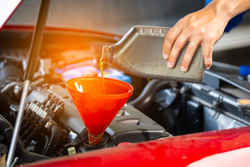 Refueling and pouring oil quality into the engine motor car Transmission and Maintenance Gear .Energy fuel concept.	
