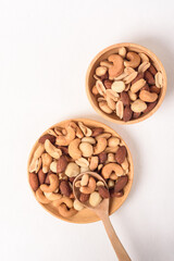 Mixed nuts consisting of almonds, cashews and peanuts, roasted with salt. Healthy snack on white background.