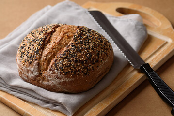 Healthy vegan dark rye sourdough bread topped with sesame and flaxseed