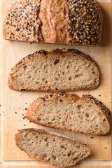 Healthy vegan dark rye sourdough bread topped with sesame and flaxseed