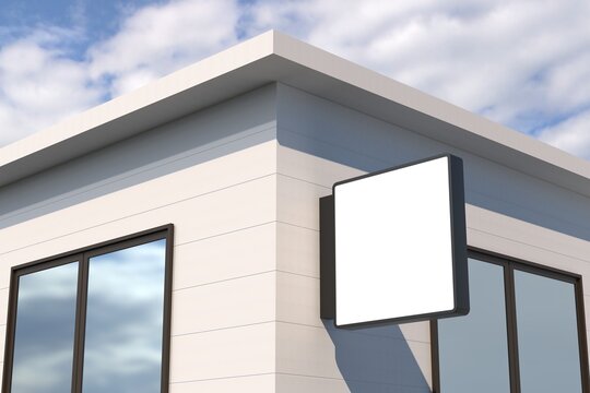 Showcase your brand with a modern square sign mockup on a building facade against a vibrant sky backdrop
