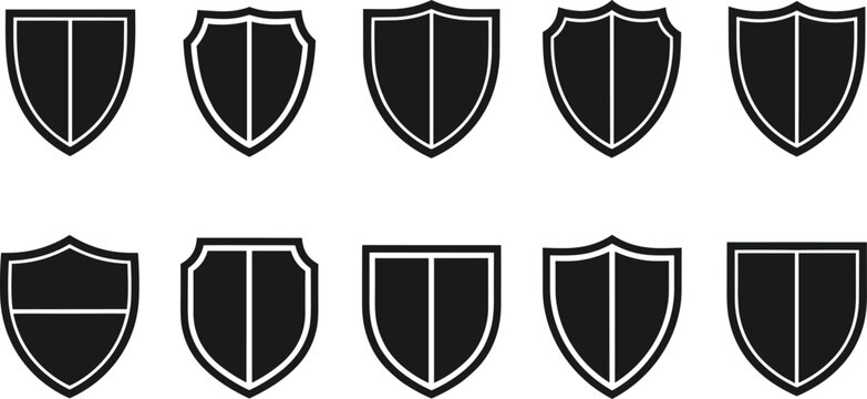 Collection of simple black and white shield icons in clean minimal vector design, blank emblem shapes for security protection branding templates