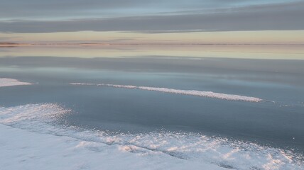Frozen Reflections: Serene Winter Morning at the Edge of a Snowy Lake, Ice