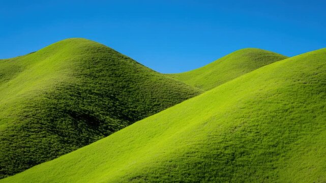 Lush green hills under a clear blue sky, perfect for landscape  or travel ry