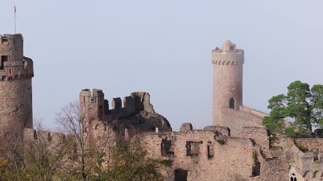 Aerial view of the stark stone ruin and tower of the Auerbach castle against a hazy sky, a vivid contrast of history and nature, Bensheim, Hessen, Germany.