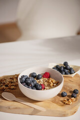 Granola bowl with blueberries, walnuts and raspberries.