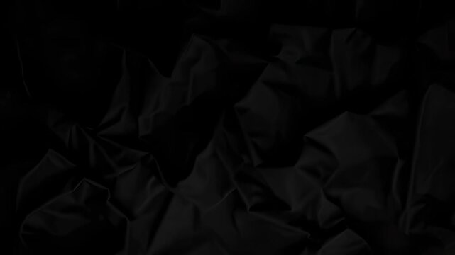 Close up of a metallic crumpled surface with sharp angular folds and varied light and shadow, creating dynamic abstract patterns suitable for design, photography, and backgrounds