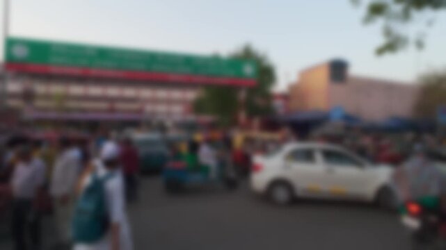 Blurry view of active vehicle and pedestrian traffic near building of Delhi Junction Railway Station in Delhi, India. Real time bokeh motion video for background
