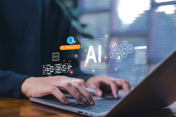 Hands typing on a laptop with a glowing AI interface and digital data graphics, representing artificial intelligence technology, and modern data-driven innovation in the workplace.