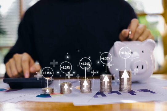 Stacks of coins with glowing growth percentages and a person calculating finances, representing investment returns, financial planning, and economic data analysis in a modern money management concept.