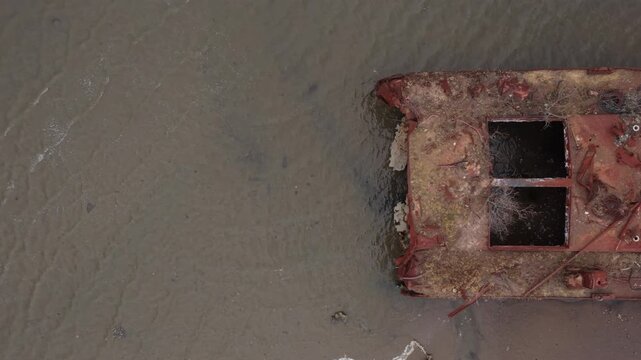alt overhead flying right over decaying boat in Staten Island Boat Graveyard