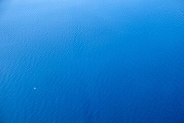 Calm blue ocean surface under bright daylight