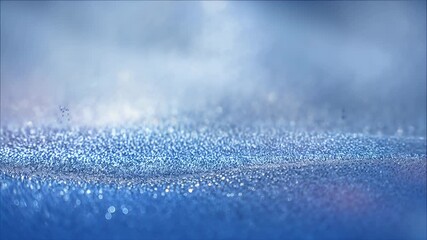 Macro close-up of a shimmering blue glitter surface with soft bokeh lights and reflective particles, creating an abstract festive texture suitable for fashion events and artwork