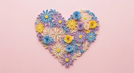 Colorful paper quilling heart featuring blue, purple, and yellow flowers on a pink background. Creative floral craft design.