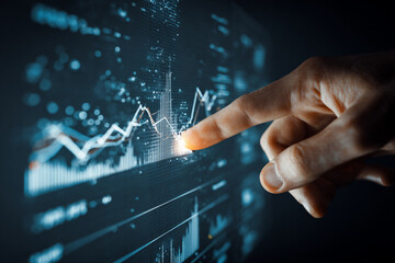 Close-up of a person's hand pointing to a digital chart with graphs and data, showing growth, with modern studio lighting.