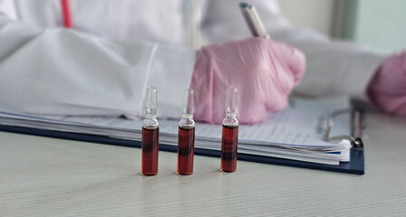 B vitamin injections. Ampoules containing red liquid. Beauty and health. Intramuscular solution in ampoules concept