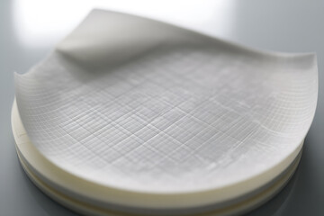 Delicate translucent layered material with subtle crosshatch texture pattern