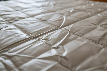 Obraz premium Quilted mattress protector surface with soft textures and square patterns