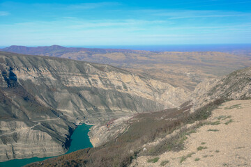 Turquoise expanse amidst cliffs: canyon reservoir