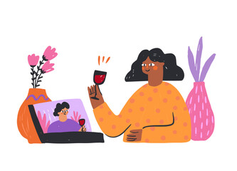 Enjoying a virtual toast while A person is raising a glass of red wine while connecting with friends on a video call. Colorful plants and a laptop screen add warmth to the cozy atmosphere of the gathe
