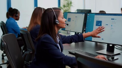 Diverse women call center operators providing online customer support, using headsets and computers with crm interface for telemarketing and helpdesk assistance in an office - Powered by Adobe