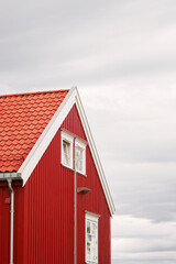 Scenic red cabin by a lake in Norway's autumnal forest
