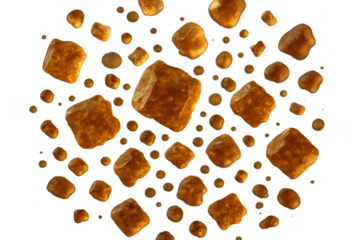 Brown sugar crystals and smaller granules falling, sweet ingredient for food and drinks on transparent background