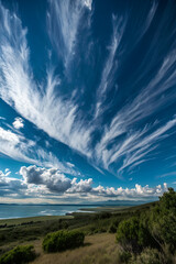 Panorama of wispy clouds against dark blue sky
