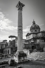 Ancient Roman column with broken capital, black and white photo