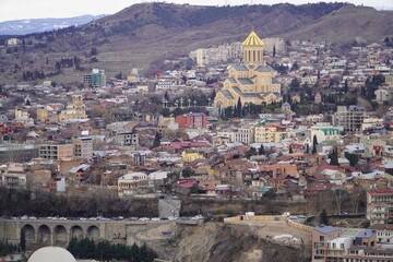 Obraz premium View of the Old Town of Tbilisi, Georgia, with the ancient Narikala fortress towering over it.