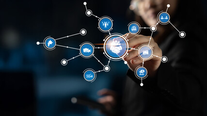 A business professional engages with a digital interface displaying network connections and icons,...
