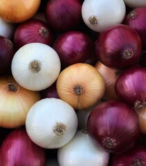Background with different types of onions - white, red, yellow omions close-up view. Natural vegetable texture
