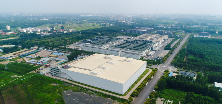 Aerial view of white factory buildings