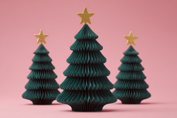 Obraz premium Three decorative paper holiday trees with golden toppers stand against a pastel pink background